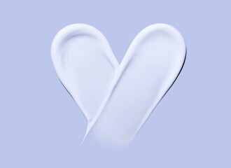 Heart shaped cosmetic smear of cream on a pastel background