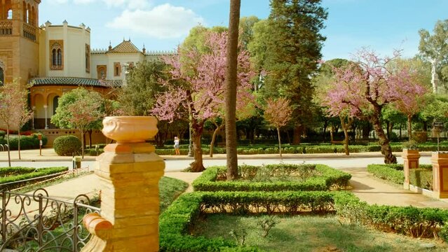 The Parque Maria Luisa, Seville, Andalusia, Spain, expansive lush park with gardens, fountains, monuments, and the impressive Plaza de Espana