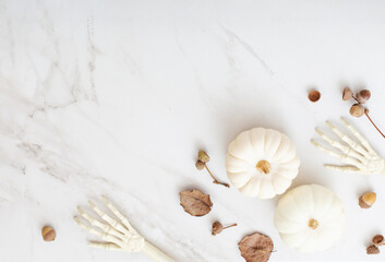 white halloween pumpkins with decor on marble background