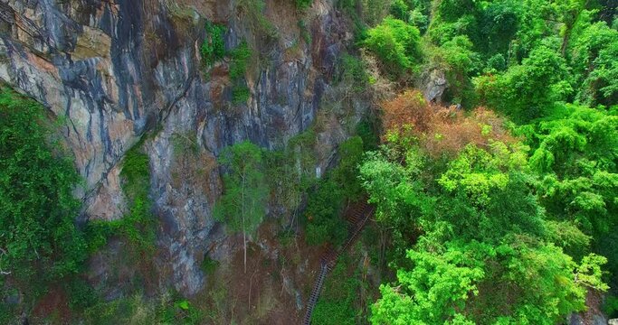 A steep staircase was built along the edge of the cliff. .under construction new bridge beside the high mountain for .tourist walk along waterfall from Tharlode Noi cave to Tharlode Yai cave  ..