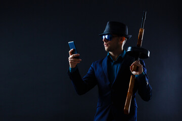 Mature man in sunglasses with gun