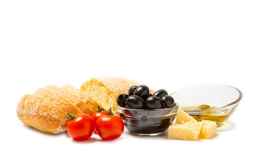 Italian ciabatta bread cut in slices with herbs, olives, garlic and parmesan cheese isolated on white background. Italian food. Delicacy. Vegan food.