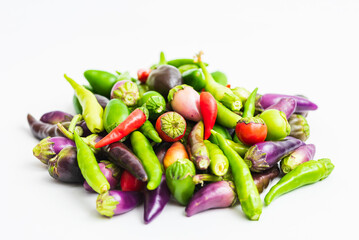 Ornamental peppers of various colors on a white background