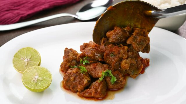 Serving mutton gravy in a plate.