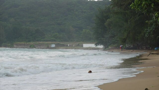 Dam Trau Beach and Waves rolling into Seashore On A Cloudy Day In Con Dao, Vietnam. static, slowmo