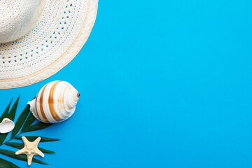 Summer holidays. Summer concept with straw hat and tropical leaf. Flat lay, top view, copy space
