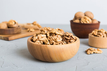 Fresh healthy walnuts in bowl on colored table background. Top view Healthy eating bertholletia concept. Super foods