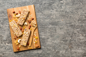 Various granola bars on table background. Cereal granola bars. Superfood breakfast bars with oats, nuts and berries, close up. Superfood concept