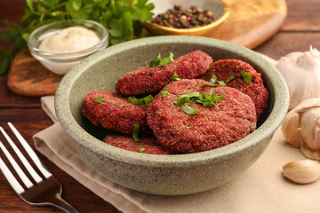 Tasty vegan cutlets served on wooden table, closeup