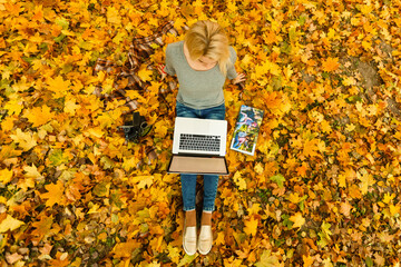 Young businesswoman working on nature with laptop