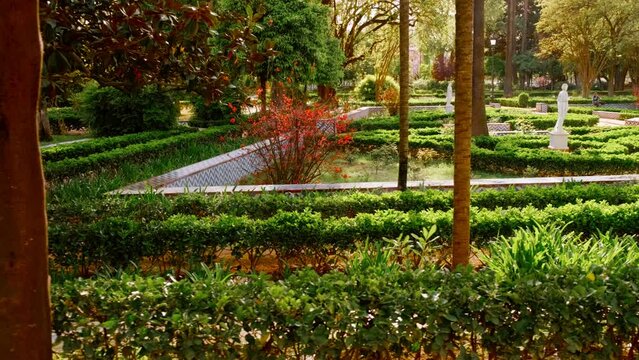 The Parque Maria Luisa, Seville, Andalusia, Spain, expansive lush park with gardens, fountains, monuments, and the impressive Plaza de Espana