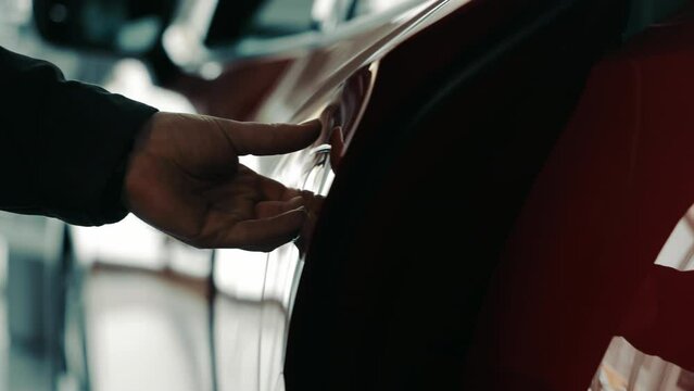 Close-up Silhouette Of A Man's Hand Closing A Car