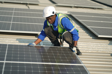 professional technician or engineer installing solar panels, Alternative energy for installed solar panels in use on roof of home © FotoArtist