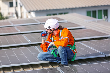 professional technician or engineer installing solar panels, Alternative energy for installed solar panels in use on roof of home