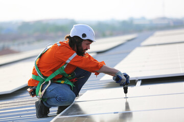 professional technician or engineer installing solar panels, Alternative energy for installed solar panels in use on roof of home