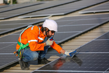 professional technician or engineer installing solar panels, Alternative energy for installed solar panels in use on roof of home