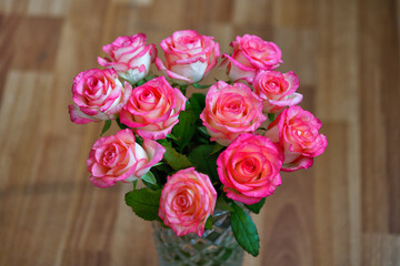 Bouquet of rose flowers on brown blurred background, horizontal orientation