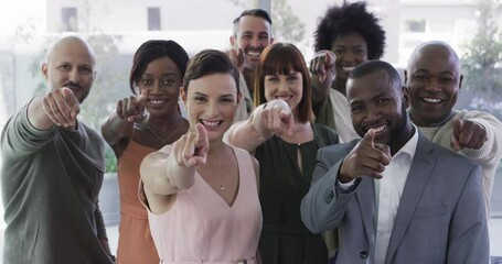 Company, staff and group point finger or faces of creative team or happy diverse people or multiethnic company and staff. Team, recruit and corporate collaboration or choice and hey you in an office - Powered by Adobe