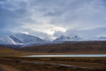 Fototapeta na wymiar snow covered mountains, cloudy sky at Kyagar Tso, Kyagar lake with surrounding mountains, Ladakh, Inida