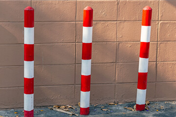 The barricades, painted in red and white, show no parking areas.