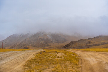 withered grass field, the mountain and cloud sky at Tso Kar lake, Beautiful scenery along the way at Ladakh, India. The Tso Kar or Tsho kar is a fluctuating salt lake