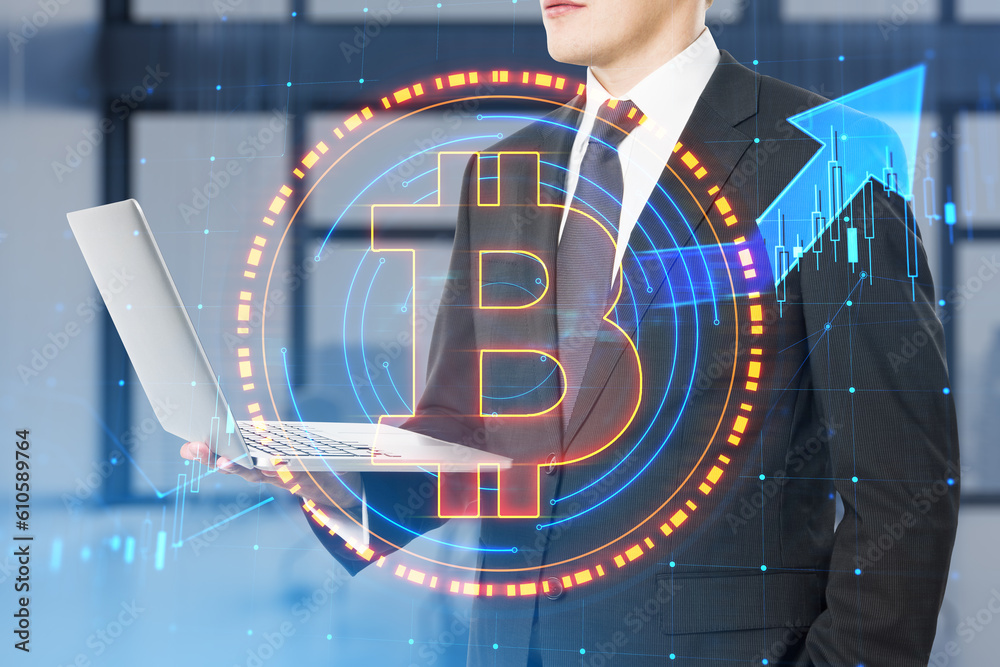 Poster close up of businessman hand using laptop with glowing round bitcoin sign and forex chart hologram o
