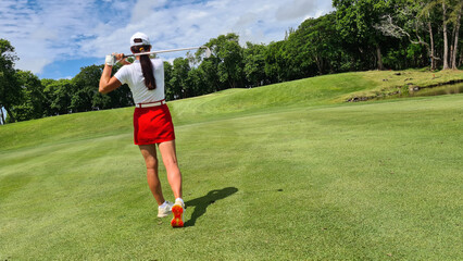 Woman golf player plays golf on golf course