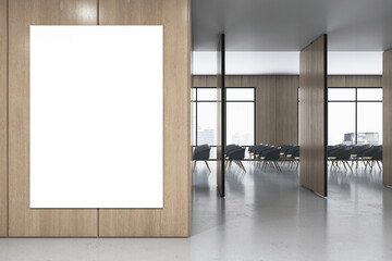 Front view on blank white poster with space for your logo or advertising text on wooden wall partition in stylish conference area with city view from big windows and chair rows. 3D rendering, mock up