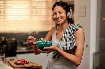 Headphones, eating breakfast and portrait of woman in kitchen with strawberry. Face headphone, food...