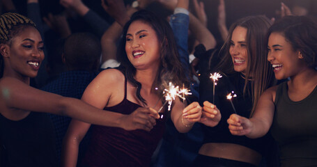 Sparkler, party and night with women in club for music, celebration and nightlife concert....
