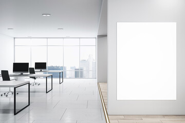 Front view on blank white poster on light grey wall with space for your logo advertising in modern open space office with table and chairs on glossy floor. 3D rendering, mockup