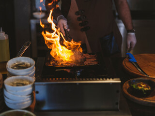 Chef cooking meat on barbecue at a celebration