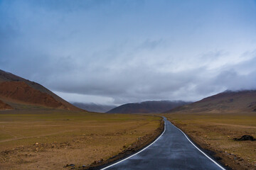  the road, mountain and cloud sky at Tanglang La pass in Ladakh, India, is the second highest...