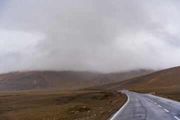  the road, mountain and cloud sky at Tanglang La pass in Ladakh, India, is the second highest motorable road in the world at 5400m