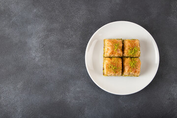 Pistachio Turkish baklava on a white plate.Traditional delicious Turkish baklava

