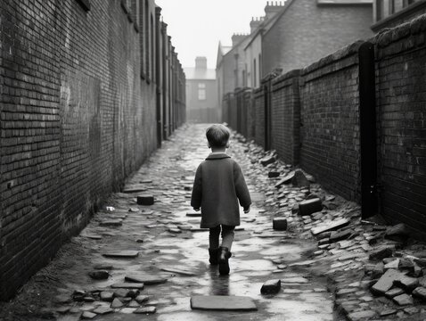 A small boy walks down an alley in 1920's britain.