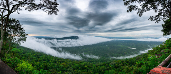 Panorama Beautiful Dark Clouds and fog above mountain, beautiful morning sunshine landscape at Pha Mo i Daeng Phra Wihan National Park. Sisaket province,Thailand,ASIA.	