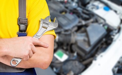 Male mechanic fix a car in the garage