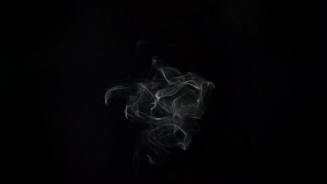 White smoke on a black background.  Top-Down Angle.
Slow motion. Shot in 4K resolution at 60fps.