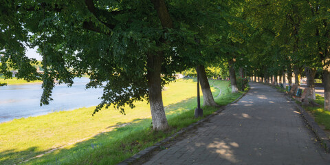 river in the town at sunrise. longest linden alley in europe. popular travel destination