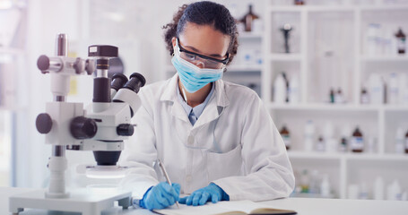 Scientist face mask, woman writing and lab worker with medical research in a clinic. Data work, planning and working of a young female employee with a notebook and microscope results for science
