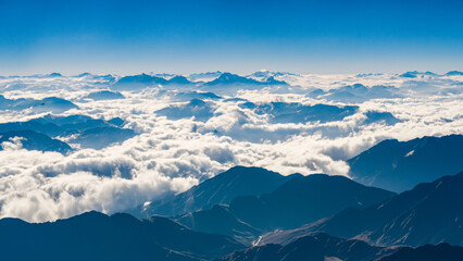 Fototapeta premium The Splendor of the Mountains Flying Through the Clouds - generative ai