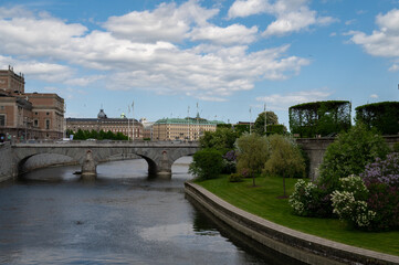 A nice stone bridge crossing the river during a cloudy weather