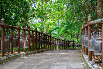 Many metallic bells hanging in a row at Doitung temple Chiangrai.