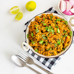 Spicy Chicken Keema Bhurji Garnished with Lemon and Cilantro Directly Above Photo