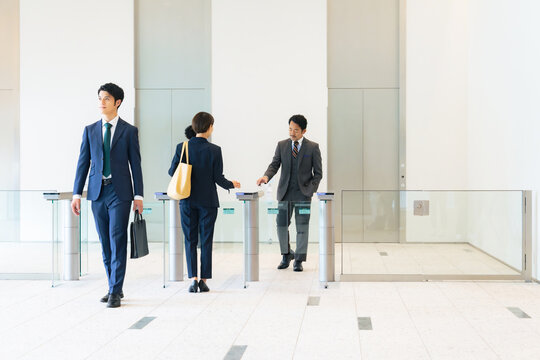 Group Of Business People Walking In Office Building Lobby.