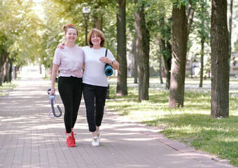 An elderly couple is resting after a run. They hug and smile. Healthy lifestyle, exercise, photo concept of mental health and active sport