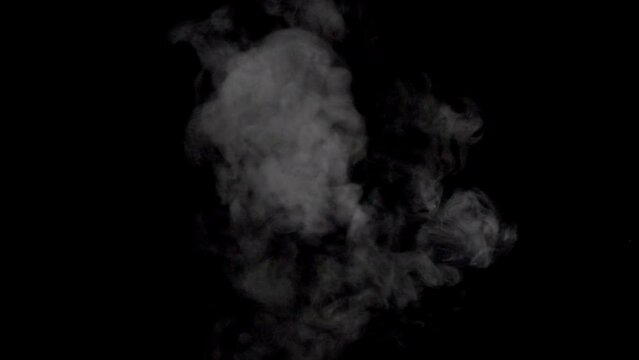 White smoke,steam on a black background.  Top-Down Angle. Slow motion. Shot in 4K resolution at 120fps.