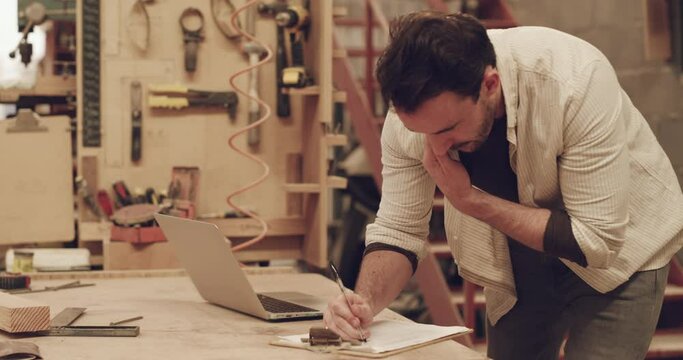 Man, phone call and carpenter writing notes in a workshop for small business planning. Male person talking on a smartphone for carpentry deal, order and ideas for creative furniture project
