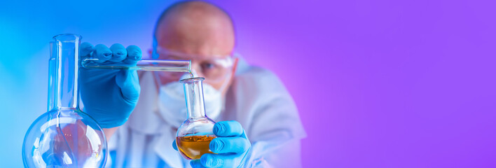 Chemist with flasks. Man with reagents. Laboratory assistant holds test tubes. Laboratory experiments. Man chemist on purple. Scientist in protective mask. Chemist is doing scientific work.